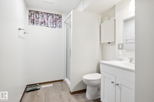 Bathroom with vanity, a shower stall, and light wood-style flooring - 83 Bellevue Crescent, St. Albert, AB - Indoor Photo Showing Bathroom