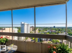 Balcony featuring a view of city and a sunroom - 