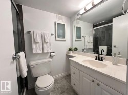 Full bathroom with vanity and a shower stall - 
