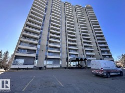 View of apartment building / complex featuring uncovered parking - 