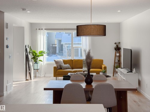 Dining room featuring baseboards and a textured ceiling - 112 Stonehouse Way, Leduc, AB - Indoor