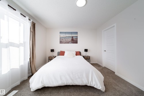 Bedroom featuring carpet and a textured ceiling - 112 Stonehouse Way, Leduc, AB - Indoor Photo Showing Bedroom