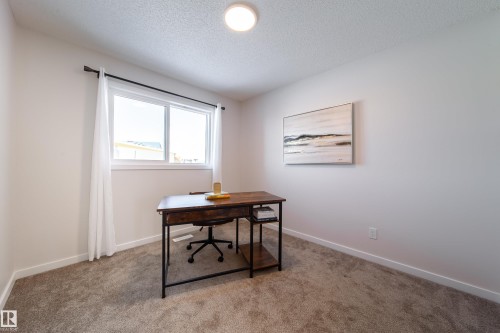 Office area with carpet and a textured ceiling - 112 Stonehouse Way, Leduc, AB - Indoor Photo Showing Office