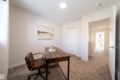 Office area featuring carpet and a textured ceiling - 112 Stonehouse Way, Leduc, AB - Indoor Photo Showing Office