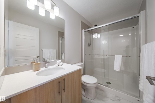 Full bathroom with vanity, a stall shower, and light marble finish flooring - 112 Stonehouse Way, Leduc, AB - Indoor Photo Showing Bathroom