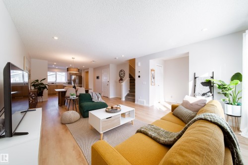 Living room featuring light wood finished floors, recessed lighting, and a textured ceiling - 112 Stonehouse Way, Leduc, AB - Indoor Photo Showing Living Room