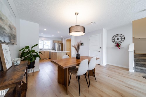 Dining room featuring light wood-type flooring, a textured ceiling, and recessed lighting - 112 Stonehouse Way, Leduc, AB - Indoor Photo Showing Dining Room
