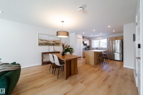 Dining room featuring a textured ceiling, light wood-style floors, and recessed lighting - 112 Stonehouse Way, Leduc, AB - Indoor Photo Showing Dining Room