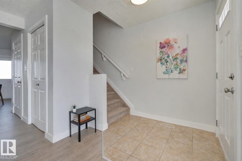 Foyer with stairway and a textured ceiling - 21 6032 38 Avenue, Edmonton, AB - Indoor Photo Showing Other Room