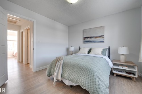 Bedroom featuring light wood-style flooring and a textured ceiling - 21 6032 38 Avenue, Edmonton, AB - Indoor Photo Showing Bedroom