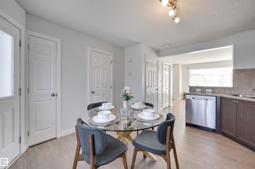 Dining room with a textured ceiling and light wood-type flooring - 21 6032 38 Avenue, Edmonton, AB - Indoor Photo Showing Dining Room