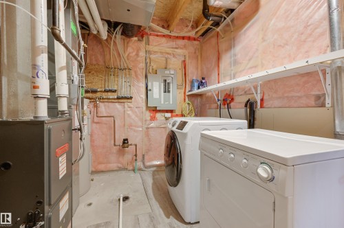 Laundry area featuring electric panel, heating unit, and washing machine and clothes dryer - 21 6032 38 Avenue, Edmonton, AB - Indoor Photo Showing Laundry Room