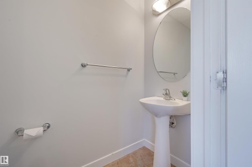 Bathroom featuring baseboards and light tile patterned floors - 21 6032 38 Avenue, Edmonton, AB - Indoor Photo Showing Bathroom