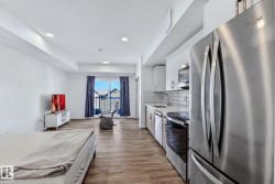 Kitchen with stainless steel appliances, white cabinets, tasteful backsplash, light wood finished floors, and recessed lighting - 