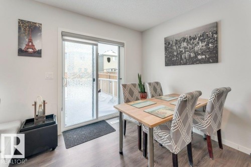 Dining space with wood finished floors and a textured ceiling - 1323 South Creek Link, Stony Plain, AB - Indoor Photo Showing Dining Room