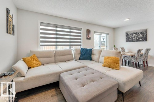 Living room with a textured ceiling and wood finished floors - 1323 South Creek Link, Stony Plain, AB - Indoor Photo Showing Living Room