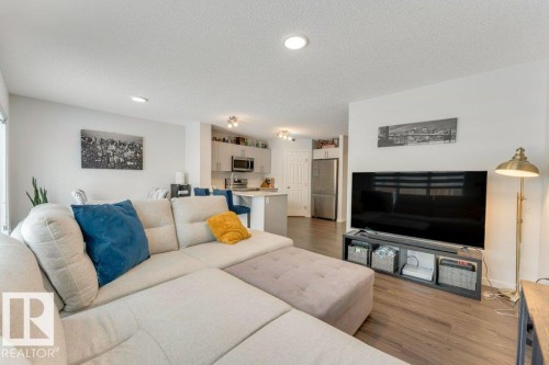 Living room featuring dark wood-style floors, recessed lighting, and a textured ceiling - 1323 South Creek Link, Stony Plain, AB - Indoor Photo Showing Living Room