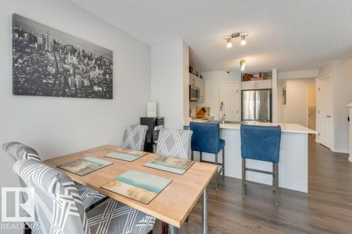 Dining area featuring dark wood-style flooring and a textured ceiling - 1323 South Creek Link, Stony Plain, AB - Indoor Photo Showing Dining Room