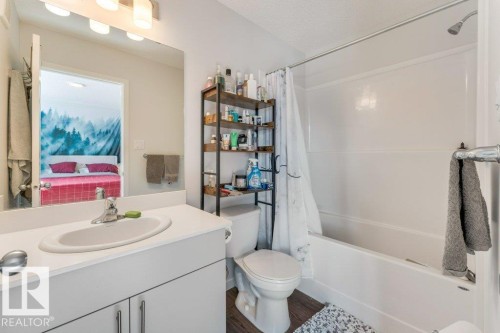 Bathroom featuring vanity, connected bathroom, shower / tub combo, and dark wood-type flooring - 1323 South Creek Link, Stony Plain, AB - Indoor Photo Showing Bathroom