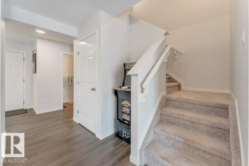 Stairway featuring wood finished floors, a textured ceiling, and recessed lighting - 1323 South Creek Link, Stony Plain, AB - Indoor Photo Showing Other Room