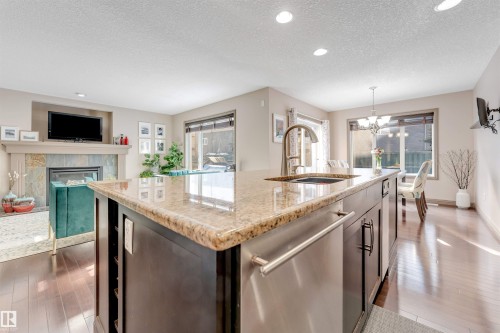 12063 21 Avenue Sw, Edmonton, AB - Indoor Photo Showing Kitchen With Fireplace