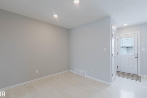 This interior space features light-colored walls and flooring, illuminated by recessed ceiling lighting - 326 Desrochers Boulevard, Edmonton, AB - Indoor Photo Showing Other Room