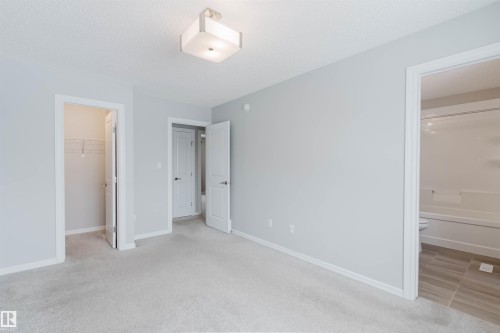 This room features light grey carpeting, light grey walls, and a white ceiling with a flush-mount light fixture - 326 Desrochers Boulevard, Edmonton, AB - Indoor Photo Showing Other Room