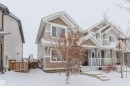The property features a two-story design with light gray siding and brown shake accents - 326 Desrochers Boulevard, Edmonton, AB  - Outdoor With Facade 