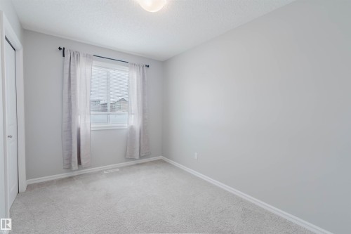 This room features light grey walls and light colored carpeting - 326 Desrochers Boulevard, Edmonton, AB - Indoor Photo Showing Other Room