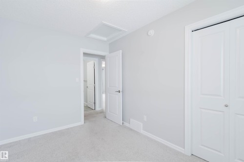 This room features light-colored walls and carpeted flooring - 326 Desrochers Boulevard, Edmonton, AB - Indoor Photo Showing Other Room