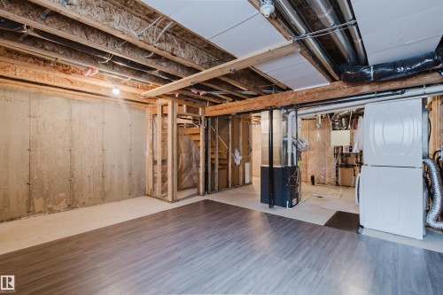 The unfinished basement provides a versatile space with concrete walls, exposed wooden beams, and a partial wood-style floor - 326 Desrochers Boulevard, Edmonton, AB - Indoor Photo Showing Basement