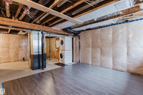 The property features an unfinished basement with exposed wooden beams, insulation, and durable flooring - 326 Desrochers Boulevard, Edmonton, AB - Indoor Photo Showing Basement