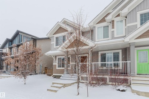 This property features a front porch with white railings, a light green front door, and a partially visible address number of 516 - 326 Desrochers Boulevard, Edmonton, AB - Outdoor With Deck Patio Veranda With Facade