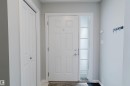 Entryway featuring a panelled door with a sidelight, light grey walls, and a closet with bifold doors - 326 Desrochers Boulevard, Edmonton, AB  - Indoor Photo Showing Other Room 