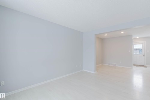 The property features light-colored walls, white trim, and light-toned flooring, creating a bright and open atmosphere - 326 Desrochers Boulevard, Edmonton, AB - Indoor Photo Showing Other Room