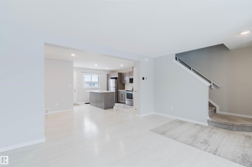 Open concept living area featuring light-colored flooring, neutral wall tones, and recessed lighting - 326 Desrochers Boulevard, Edmonton, AB - Indoor