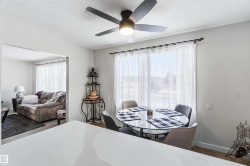 Bedroom with dark wood-type flooring, ceiling fan, and a textured ceiling - 4615 49 Avenue, Redwater, AB - Indoor