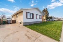 Exterior featuring white siding, stucco finish, and a concrete driveway - 4615 49 Avenue, Redwater, AB  - Outdoor With Exterior 