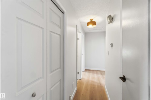 Hallway featuring light wood-style flooring and a textured ceiling - 4615 49 Avenue, Redwater, AB - Indoor Photo Showing Other Room