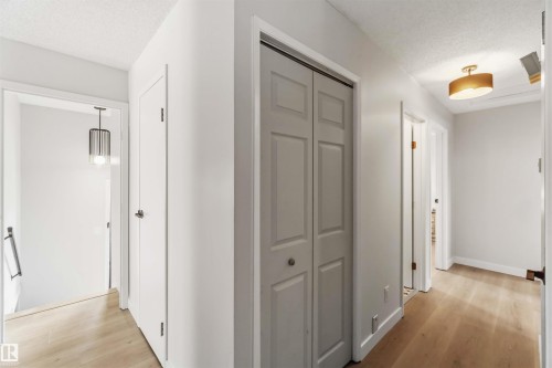 Corridor featuring a textured ceiling and light wood-style flooring - 4615 49 Avenue, Redwater, AB - Indoor Photo Showing Other Room