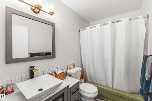 Full bath with vanity and shower / bathtub combination with curtain - 4615 49 Avenue, Redwater, AB - Indoor Photo Showing Bathroom