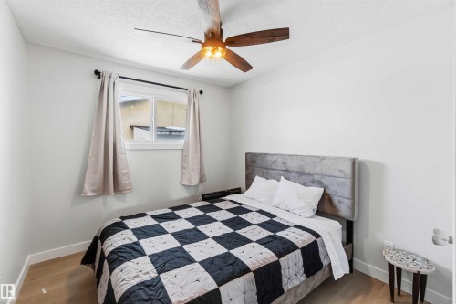 Bedroom featuring light wood-style floors, ceiling fan, and a textured ceiling - 4615 49 Avenue, Redwater, AB - Indoor Photo Showing Bedroom