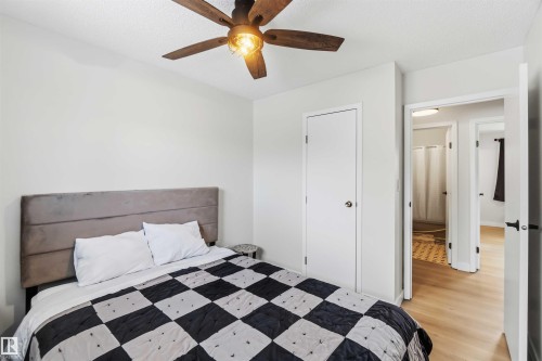 Bedroom with light wood finished floors, a textured ceiling, ceiling fan, and a closet - 4615 49 Avenue, Redwater, AB - Indoor Photo Showing Bedroom