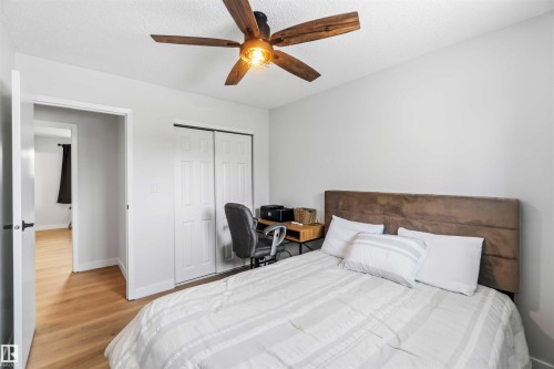 Bedroom with a closet, ceiling fan, light wood-style floors, and a textured ceiling - 4615 49 Avenue, Redwater, AB - Indoor Photo Showing Bedroom