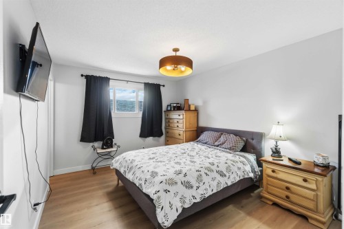 Bedroom with light wood-style floors - 4615 49 Avenue, Redwater, AB - Indoor Photo Showing Bedroom