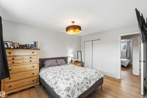 Bedroom featuring light wood finished floors and a closet - 4615 49 Avenue, Redwater, AB - Indoor Photo Showing Bedroom