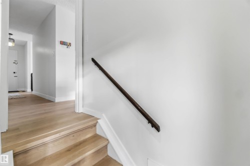 Stairs featuring wood finished floors and baseboards - 4615 49 Avenue, Redwater, AB - Indoor Photo Showing Other Room