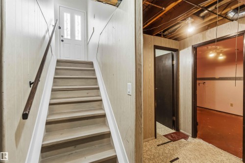 Stairway with wooden walls - 4615 49 Avenue, Redwater, AB - Indoor Photo Showing Other Room