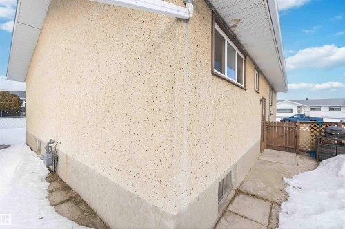 View of snow covered exterior featuring a gate and stucco siding - 4615 49 Avenue, Redwater, AB - Outdoor With Exterior