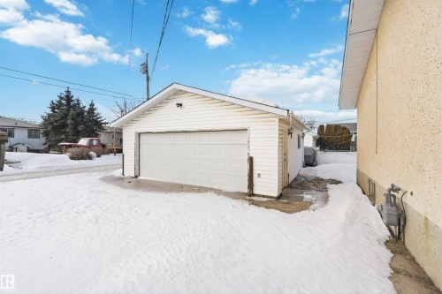 Snow covered garage with a detached garage and oil tank - 4615 49 Avenue, Redwater, AB - Outdoor With Exterior